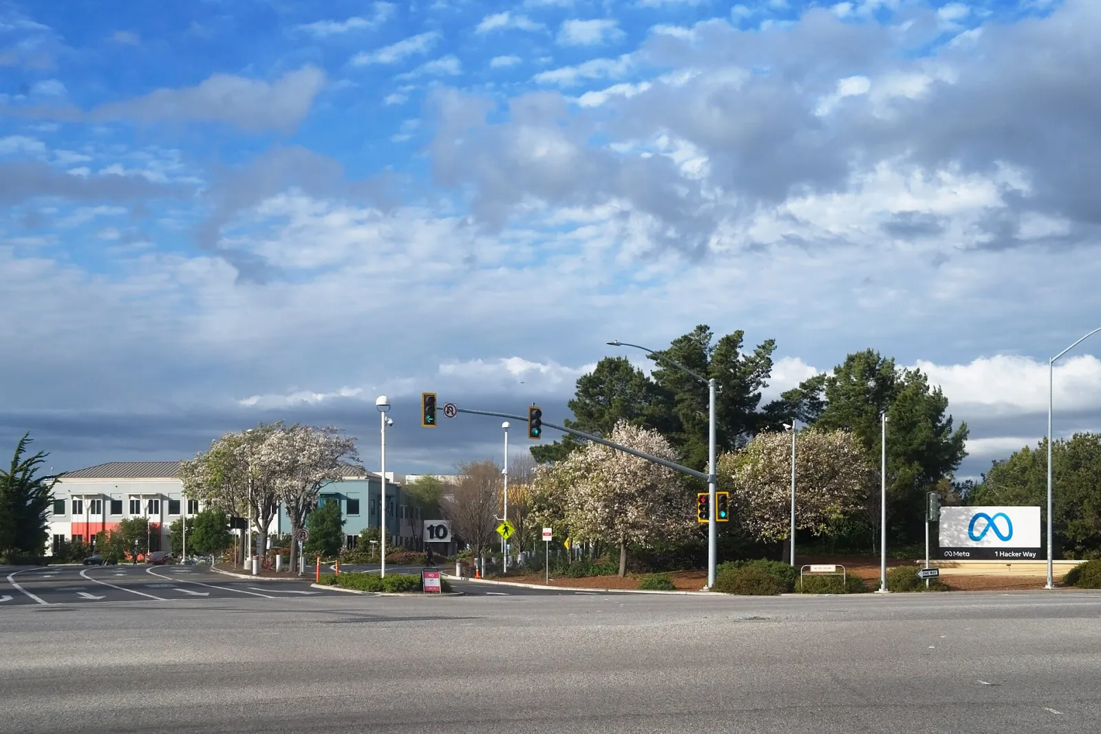 The entrance to Meta's headquarters campus in Menlo Park, California, with the company sign beside the road