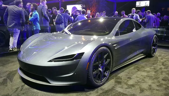 The silver Tesla Roadster prototype first shown in 2017, on display at a crowded event