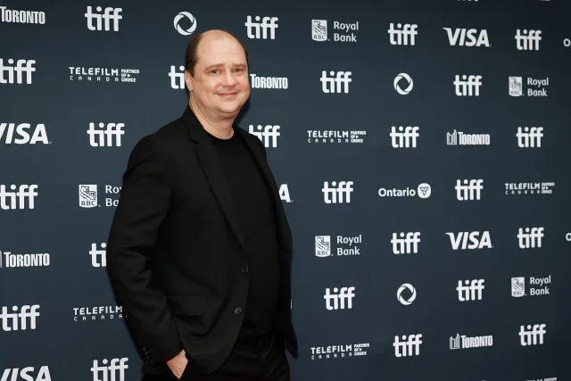 Director Mike Flanagan in a black suit on the red carpet at the Toronto International Film Festival