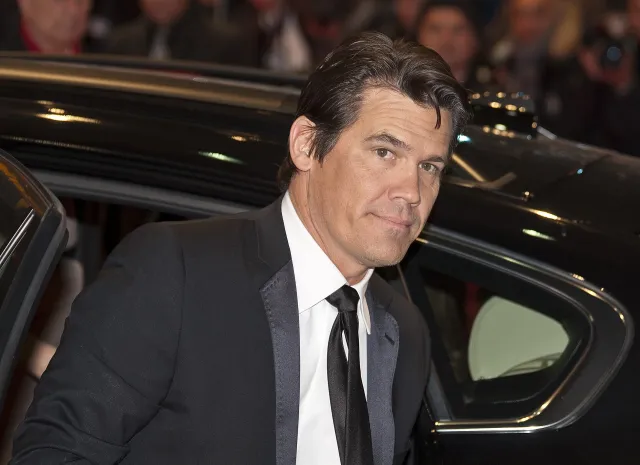 Josh Brolin in a dark suit and tie at an evening film premiere